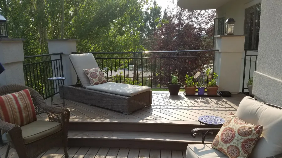 Custom Decks Timbertech dark roast deck two levels stucco columns custom wrough iron railing stamped concrete patio littleton colorado