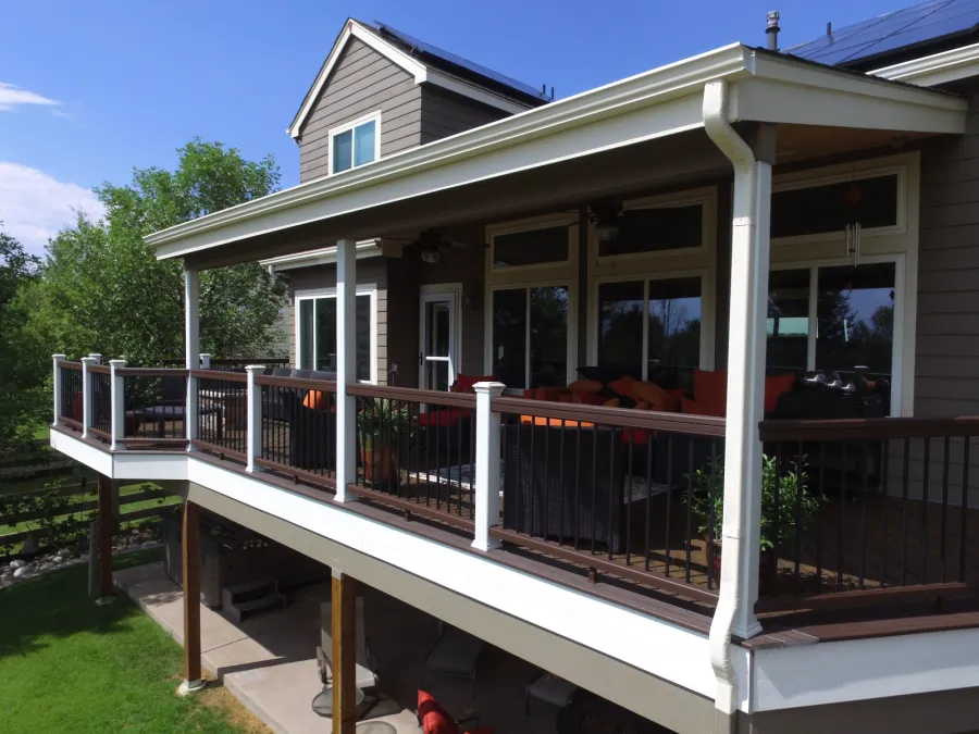 Custom Decks shed style patio cover tongue and groove ceiling can lights two fans posts wrapped in white trex post sleeves Aurora Colorado