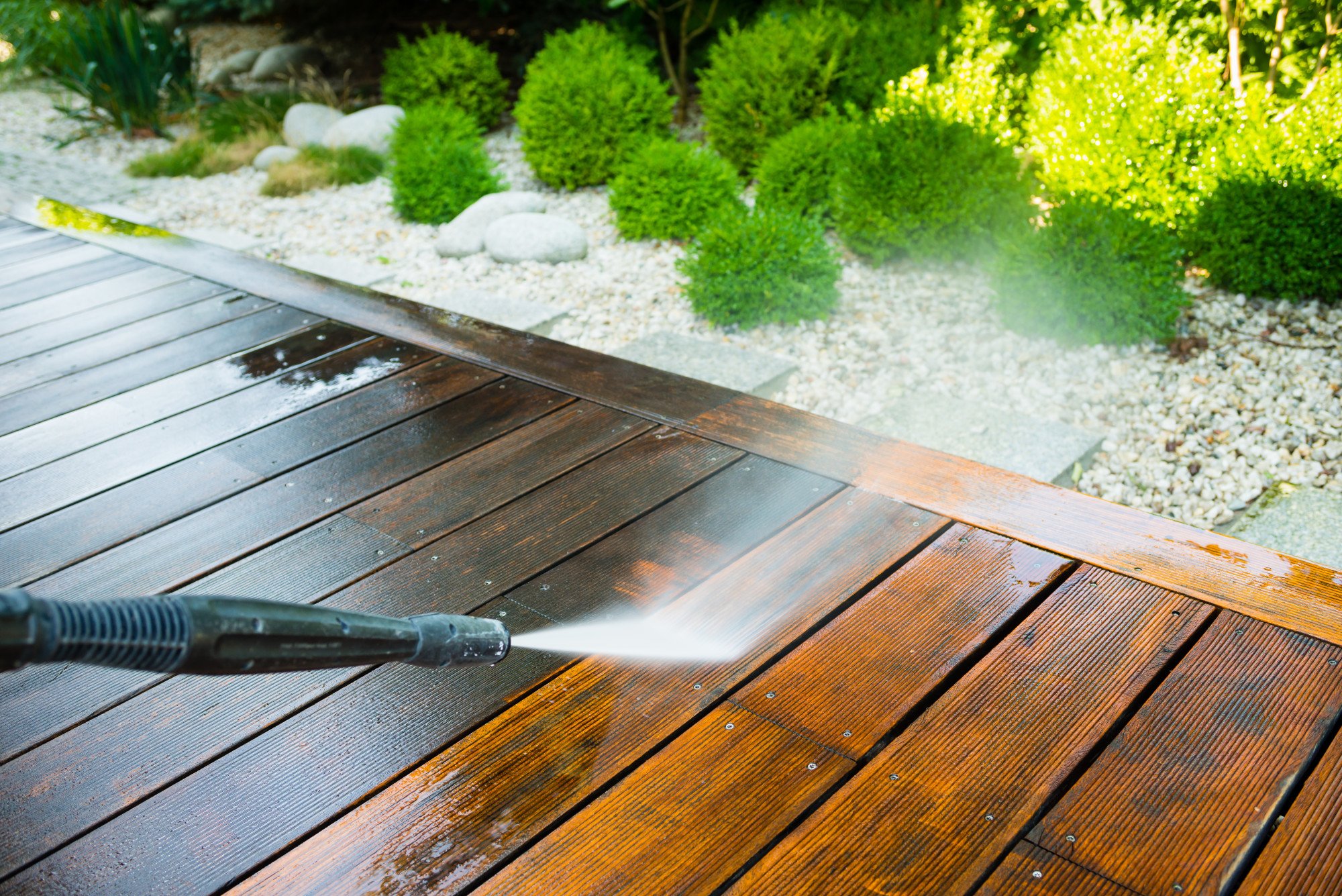 Cleaning Terrace With A Power Washer High Water Pressure Cleaner On Wooden Terrace Surface